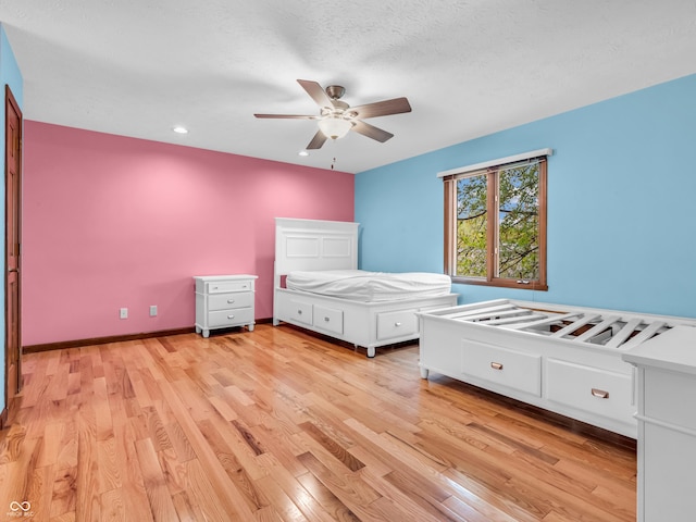 unfurnished bedroom with recessed lighting, ceiling fan, and light wood-style flooring