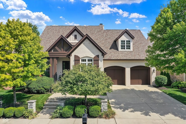 view of front of home featuring driveway, a shingled roof, a garage, and brick siding