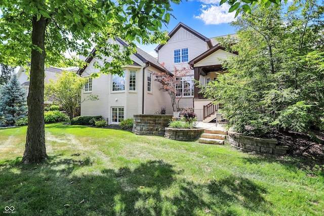 back of house with a lawn