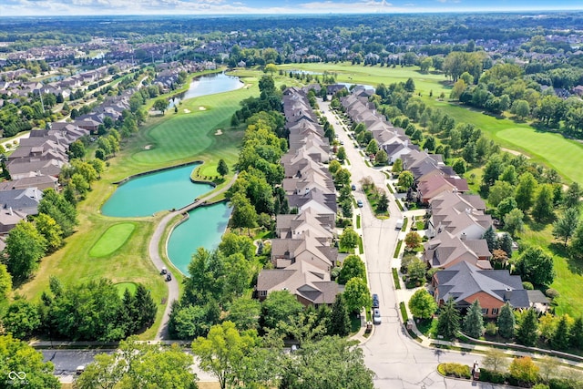 bird's eye view with view of golf course, a water view, and a residential view