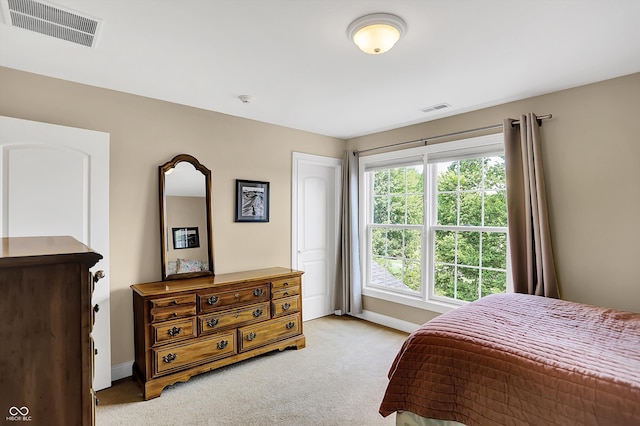 bedroom featuring light carpet, baseboards, and visible vents