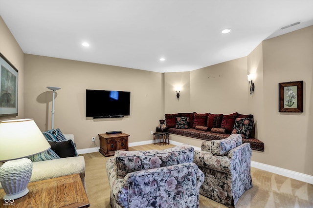 living room with recessed lighting, visible vents, and baseboards