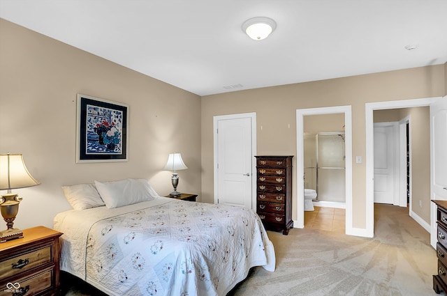 bedroom with light carpet, connected bathroom, and baseboards