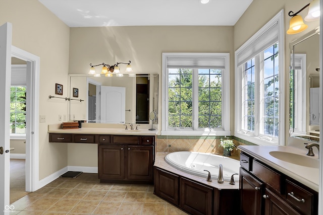 bathroom with a jetted tub, tile patterned flooring, two vanities, and a sink