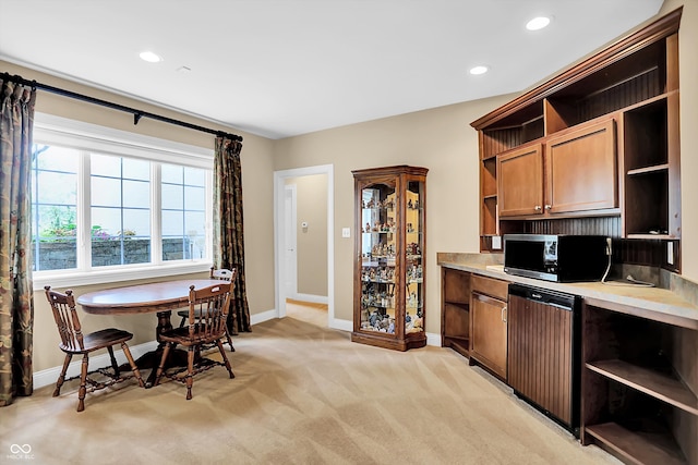 kitchen with light carpet, baseboards, light countertops, open shelves, and stainless steel microwave