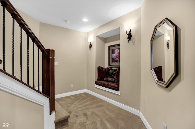 foyer entrance with carpet, stairway, and baseboards