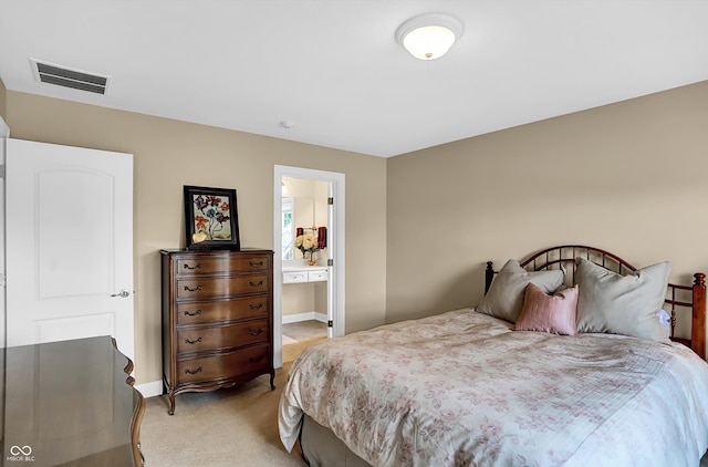 bedroom with light carpet, ensuite bath, visible vents, and baseboards