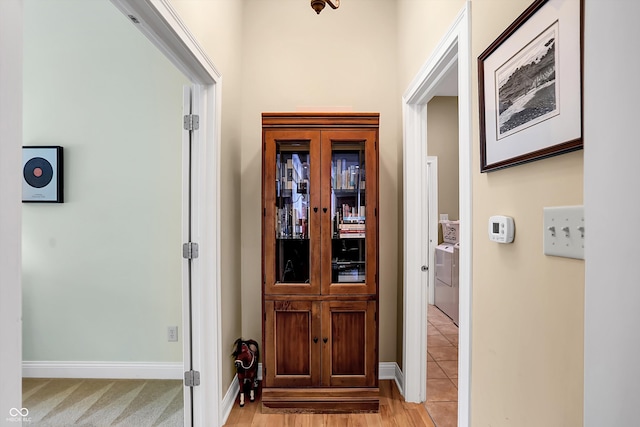 entryway with washer / dryer and baseboards