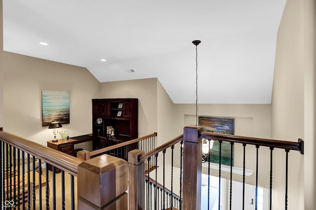 corridor featuring recessed lighting, visible vents, vaulted ceiling, and an upstairs landing