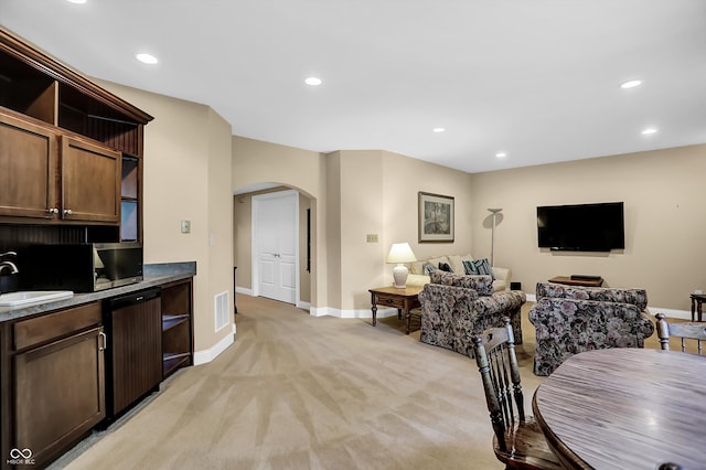 dining area with light carpet, baseboards, arched walkways, and recessed lighting