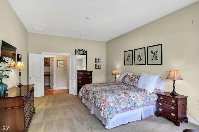 bedroom featuring light carpet, visible vents, and baseboards