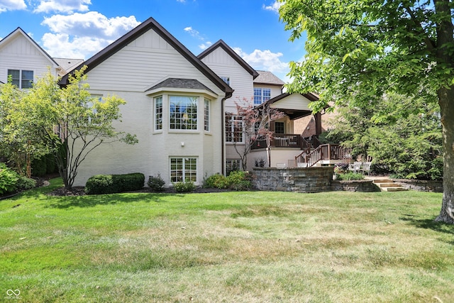 rear view of property featuring a lawn