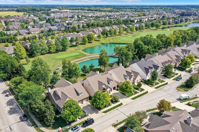 bird's eye view featuring a water view, view of golf course, and a residential view