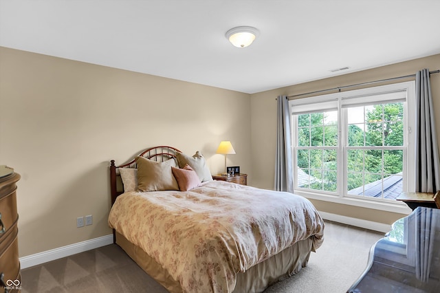 bedroom featuring carpet flooring, visible vents, and baseboards