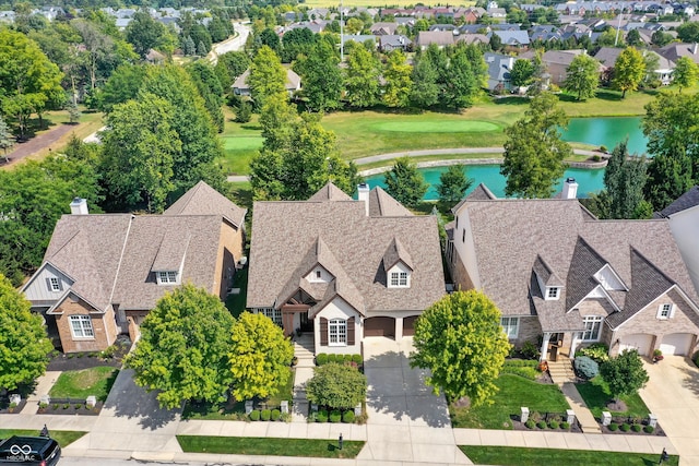 drone / aerial view featuring a water view and a residential view