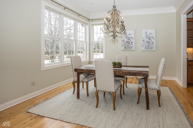 dining area featuring ornamental molding, light wood-style flooring, and baseboards