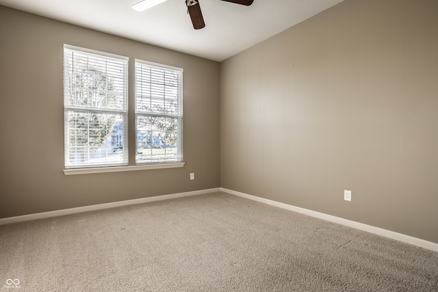 carpeted empty room featuring ceiling fan