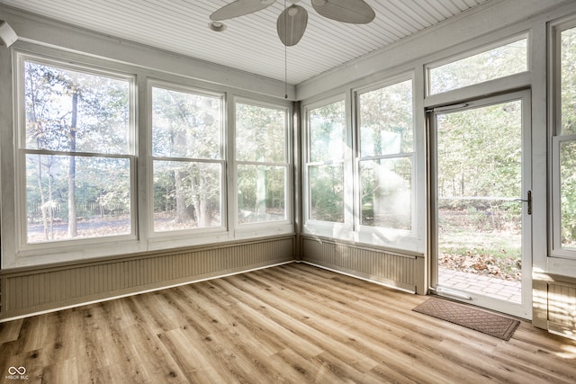 unfurnished sunroom with a healthy amount of sunlight and ceiling fan