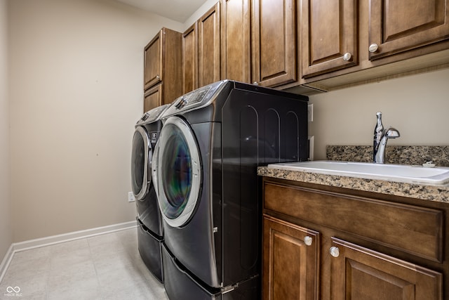 laundry area with independent washer and dryer, cabinets, and sink