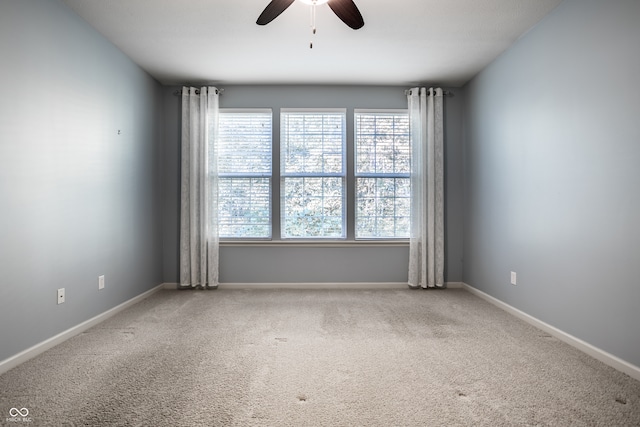 empty room with ceiling fan and carpet flooring