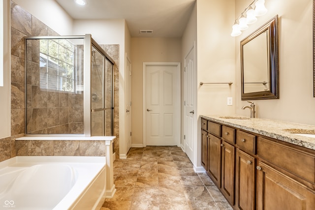 bathroom with vanity and separate shower and tub