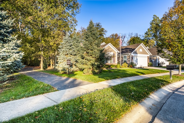 view of front of property with a front yard and a garage