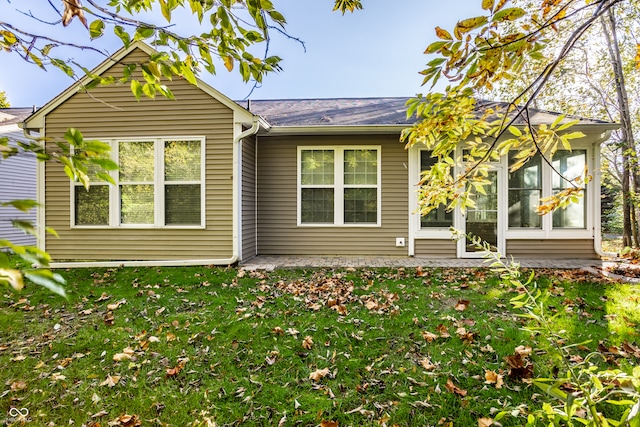 rear view of house with a lawn