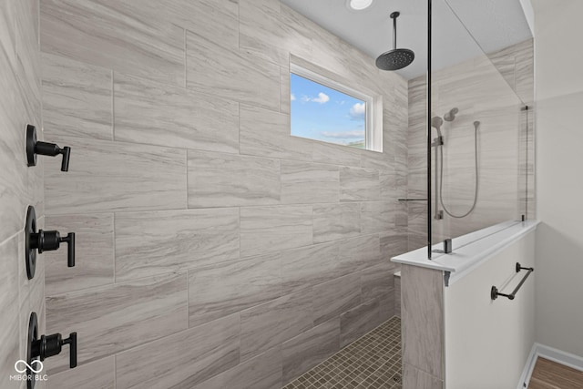 bathroom featuring a tile shower