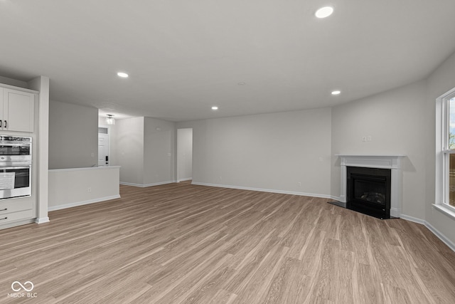 unfurnished living room featuring light wood-type flooring