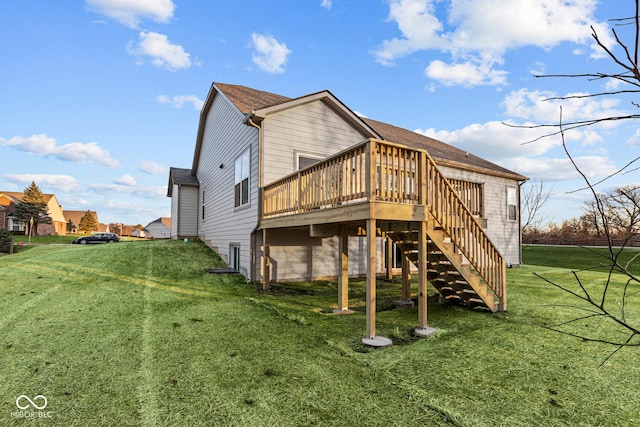 rear view of house featuring a lawn and a wooden deck