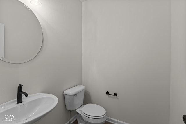 bathroom featuring toilet and sink