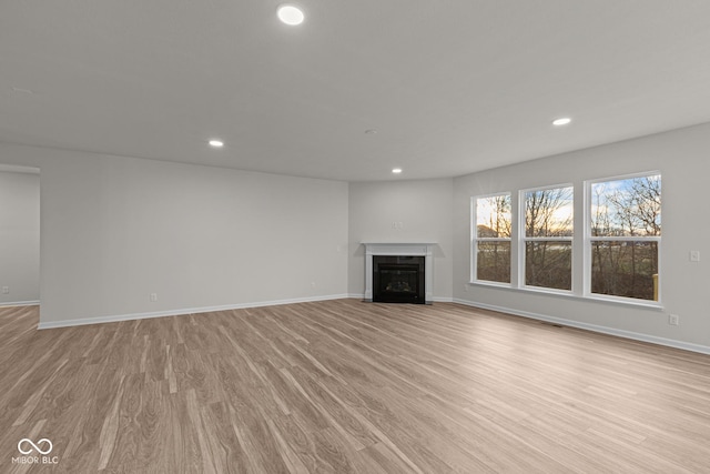 unfurnished living room featuring light hardwood / wood-style floors