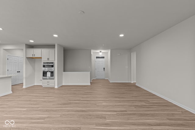 unfurnished living room with light wood-type flooring