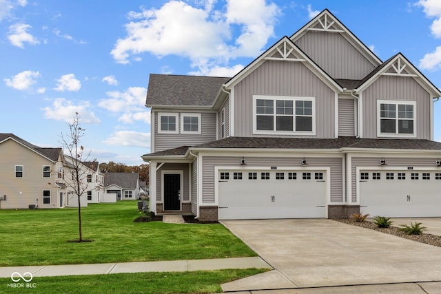 craftsman inspired home featuring a garage and a front lawn