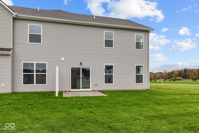 rear view of property with a lawn and a patio area