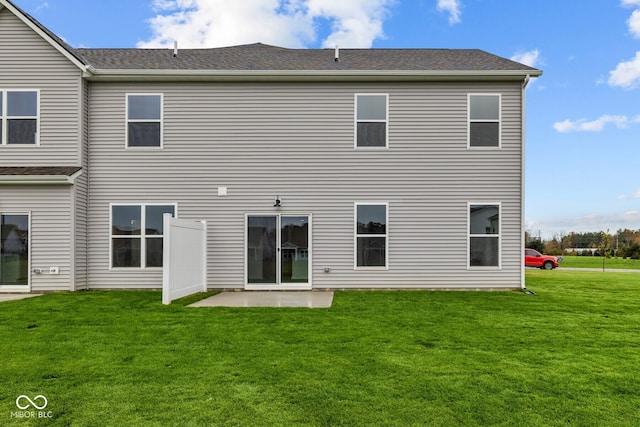 back of property with a patio and a lawn