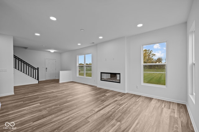 unfurnished living room featuring light wood-type flooring