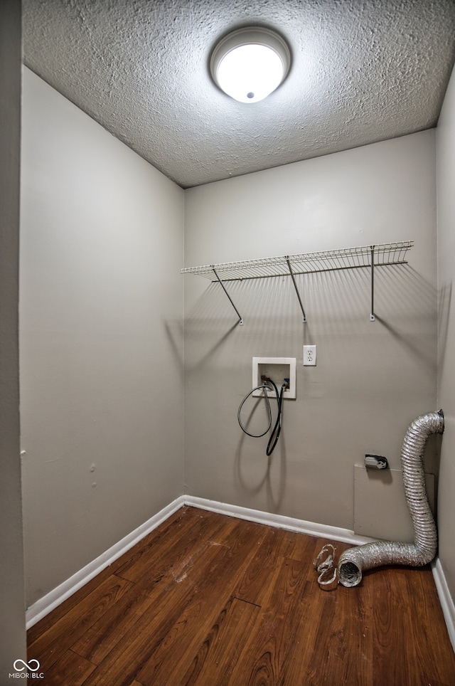 washroom featuring washer hookup, a textured ceiling, and dark hardwood / wood-style flooring