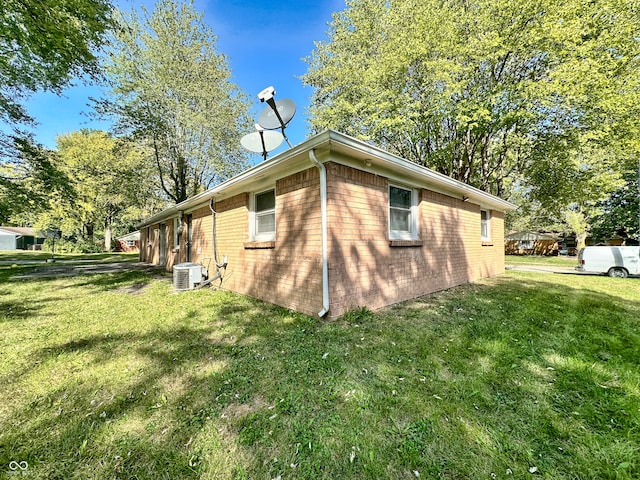 view of property exterior with central AC unit and a lawn