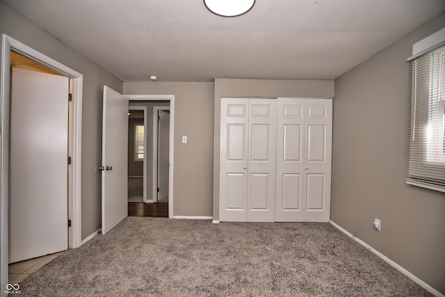 unfurnished bedroom with a closet and carpet