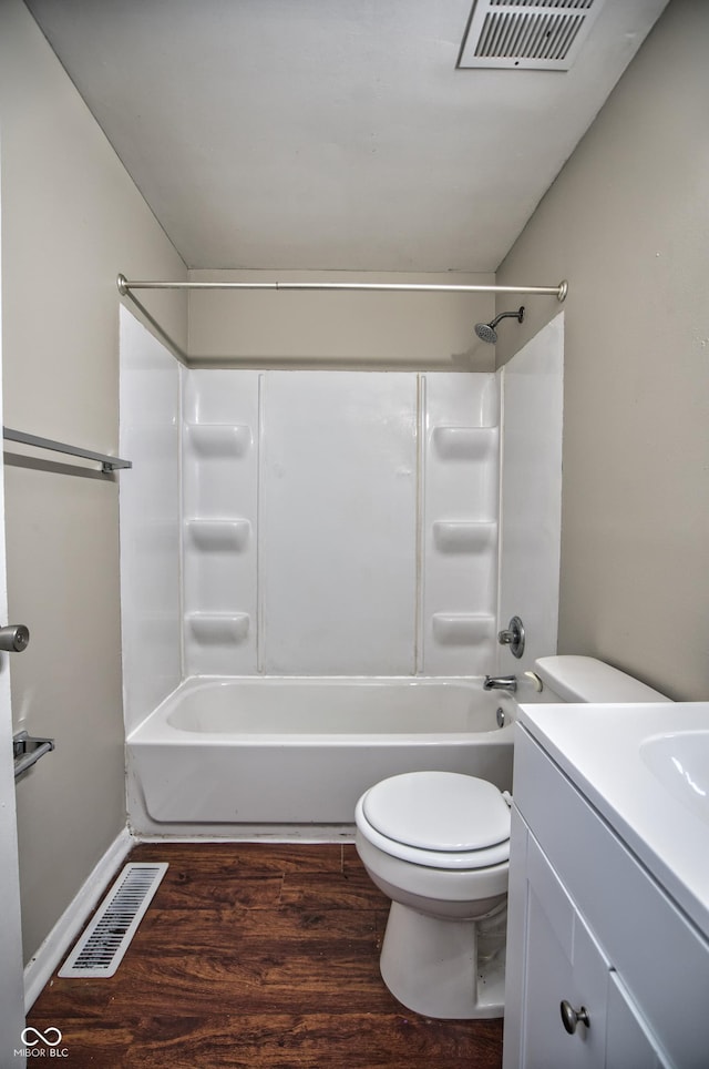 full bathroom featuring shower / bathtub combination, hardwood / wood-style flooring, toilet, and vanity