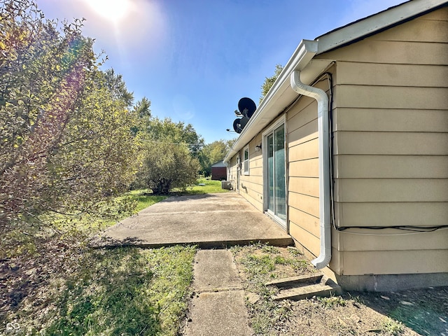 view of side of home with a patio area