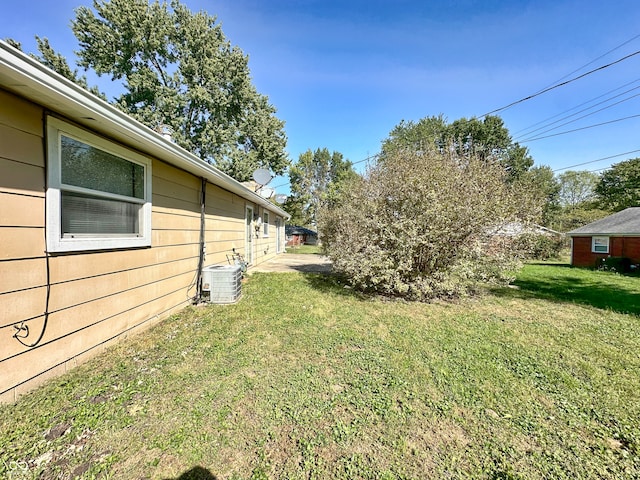 view of yard featuring central air condition unit