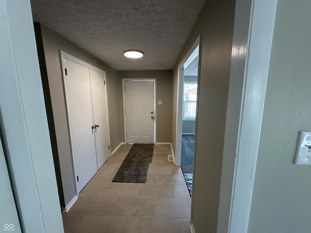 corridor featuring a textured ceiling