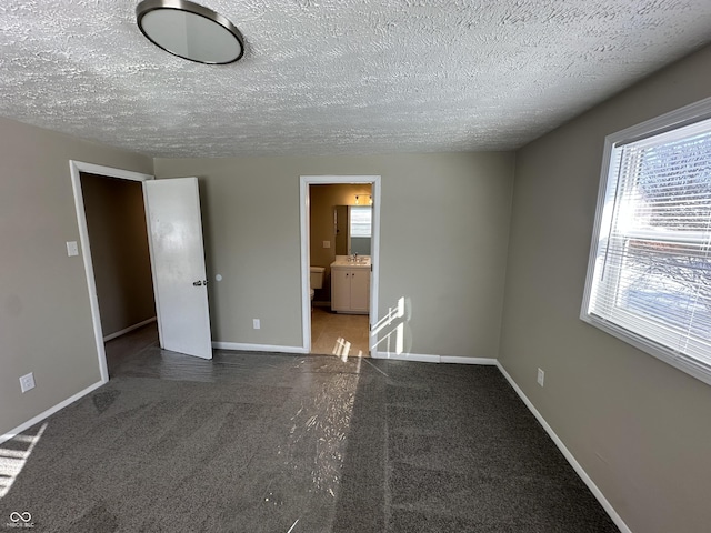 spare room with sink and a textured ceiling