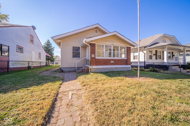 bungalow-style house featuring a front yard