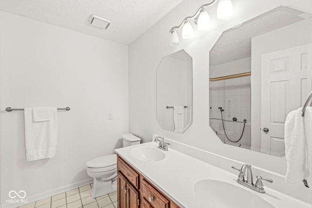 bathroom featuring toilet, a shower, a textured ceiling, vanity, and tile patterned flooring