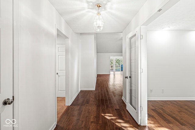 corridor featuring dark wood-type flooring