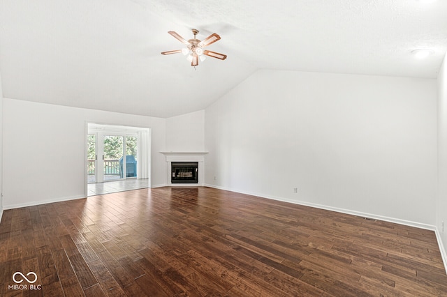 unfurnished living room featuring lofted ceiling, dark wood-type flooring, and ceiling fan