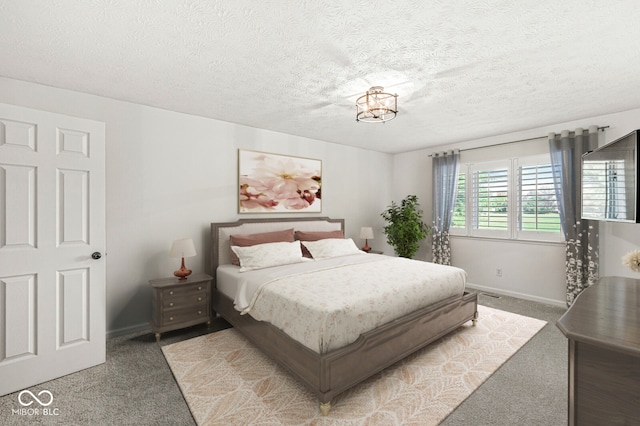 bedroom with a textured ceiling and carpet flooring